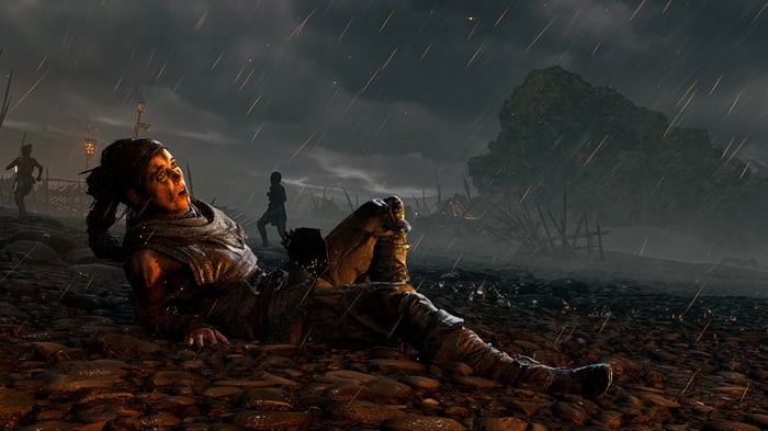 Woman lying on the ground in the rain