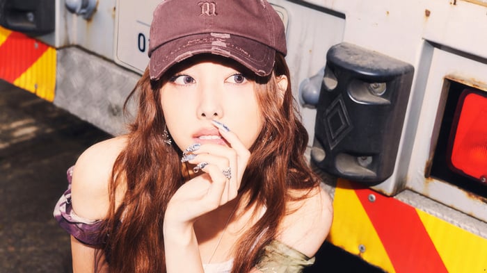 Nayeon from TWICE wearing a brown cap