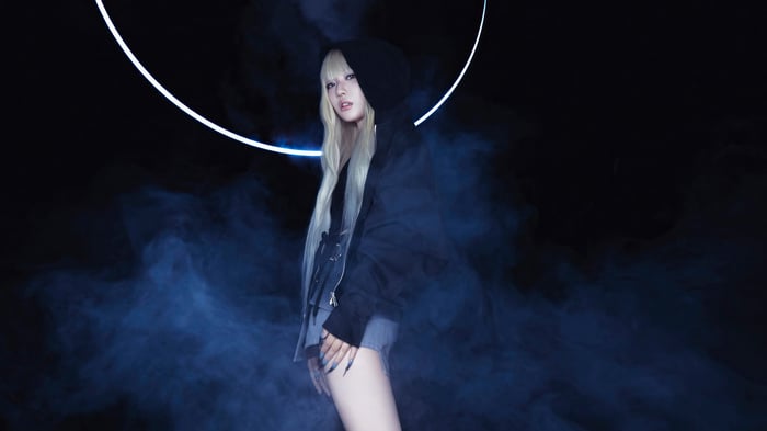 Ningning from Aespa in a dark, smoky setting with a neon ring
