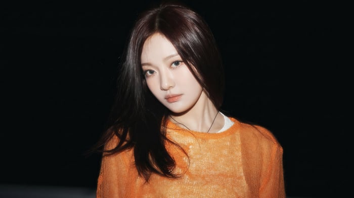 Ningning from Aespa in an orange sweater