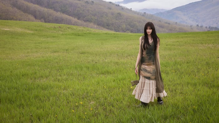 Giselle from Aespa in a grassy field
