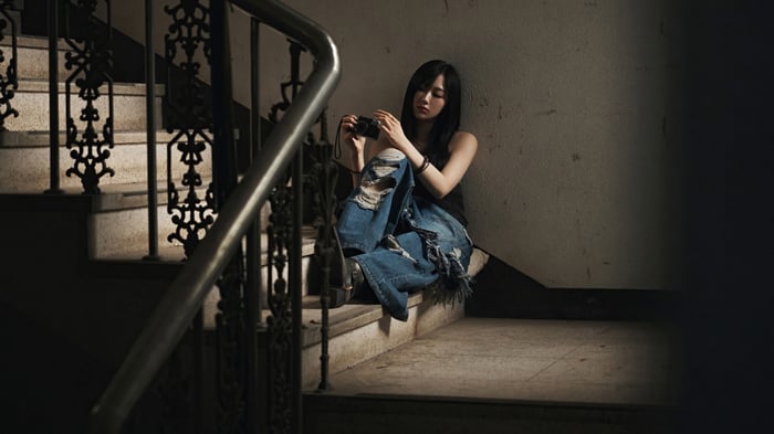 Aespa Giselle holding a camera on stairs