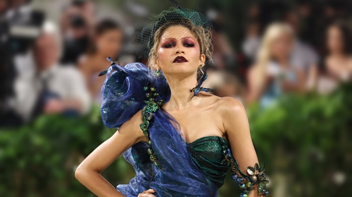 Zendaya in a blue and green gown with dramatic makeup