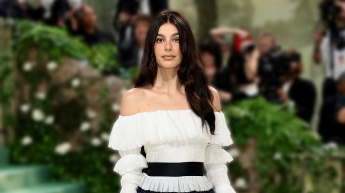 Camila Morrone in a white off-the-shoulder top