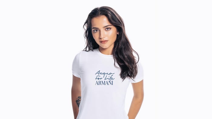 Isabela Merced wearing a white t-shirt with Armani logo