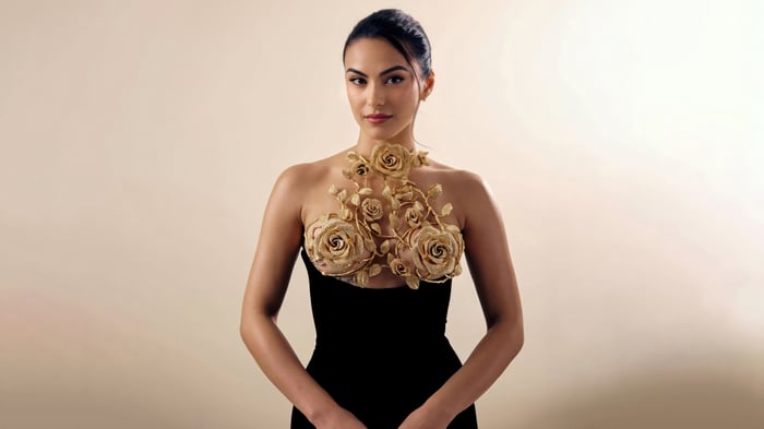Camila Mendes in a black dress with floral embellishments