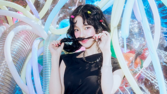 Winter from Aespa with long braids and colorful balloons