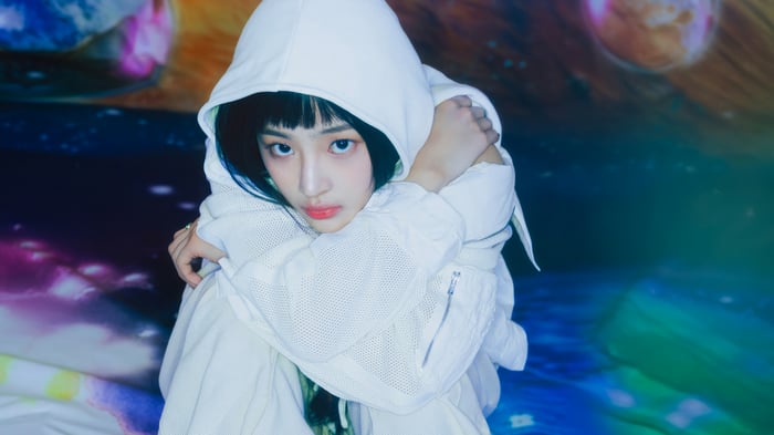 Minji from NewJeans in a white hoodie
