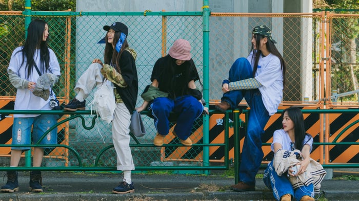 NewJeans members posing outdoors