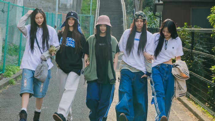 NewJeans members walking on a street