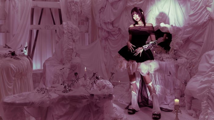 Rei from IVE in a dark dress with white accents