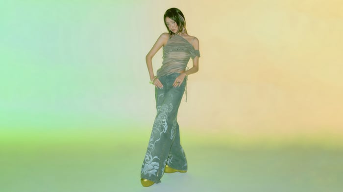 Rei from IVE in a sheer top and patterned jeans