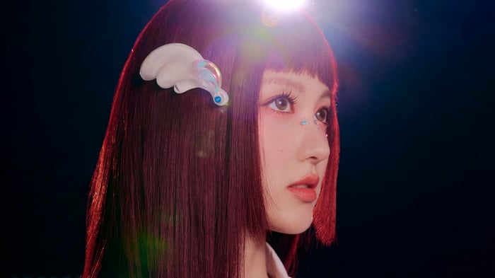 Gaeul from IVE with red hair and wing accessory