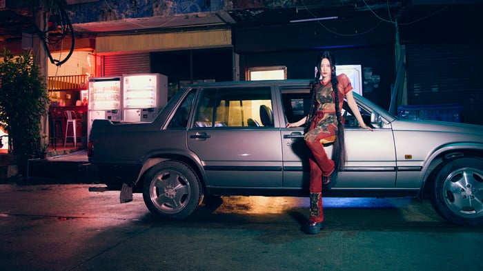 Ningning from Aespa poses by a car at night