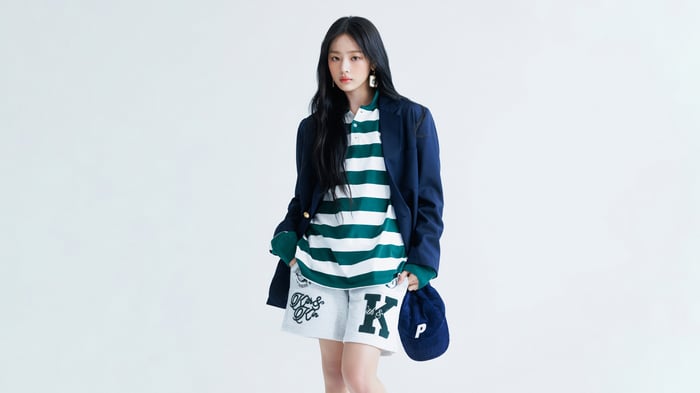 Minji from NewJeans in a navy blazer and striped shirt