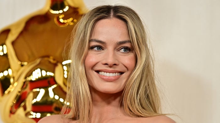 Margot Robbie smiling at an event