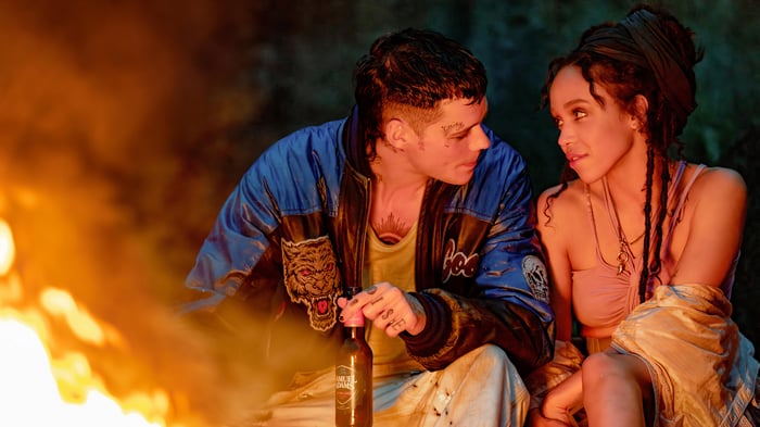Bill Skarsgard and FKA Twigs by a Fire