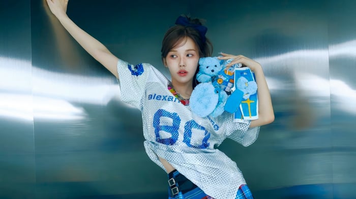 Wendy from Red Velvet holding a blue teddy bear