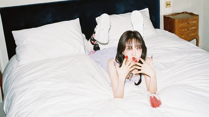 Wendy from Red Velvet lying on a bed
