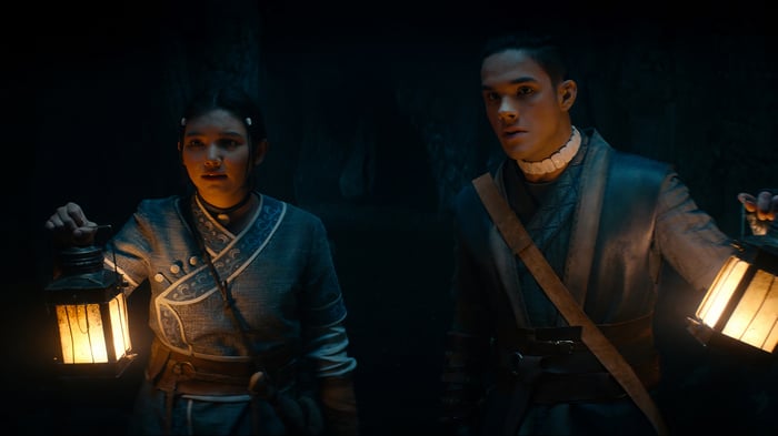 Katara and Sokka with lanterns in a cave