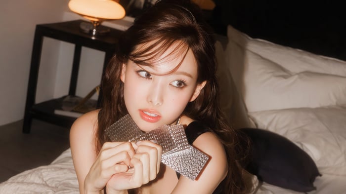 Nayeon from TWICE holding a silver object