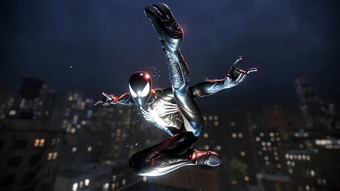 Spider-Man in black suit leaping over city at night
