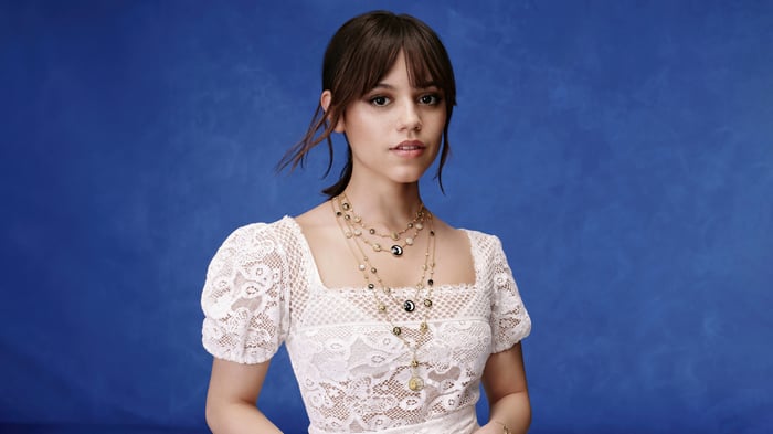 Jenna Ortega in white lace top with necklaces