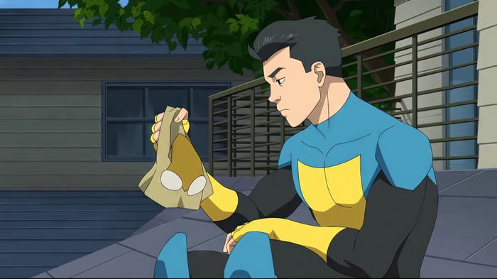 Invincible holding a mask