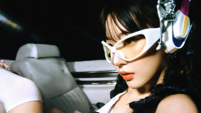 Sakura Miyawaki in white sunglasses and headphones