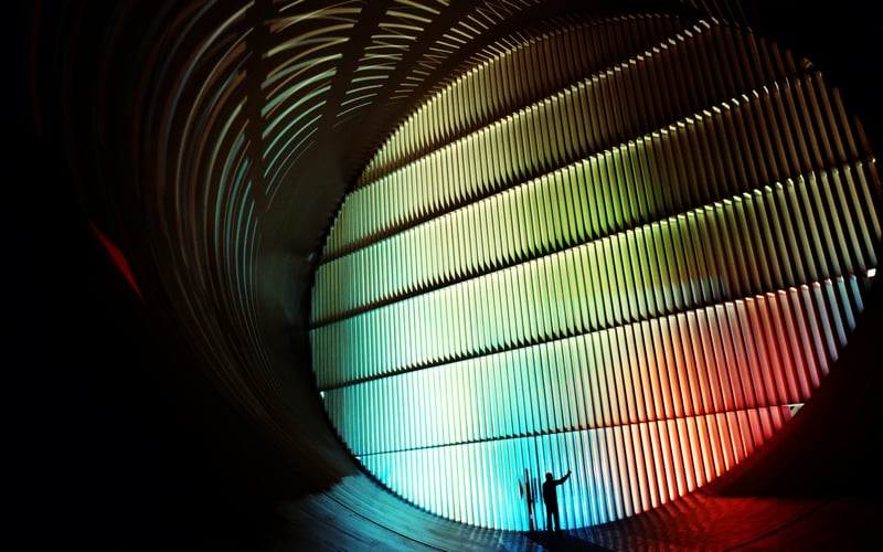 Silhouette in a colorful, illuminated tunnel