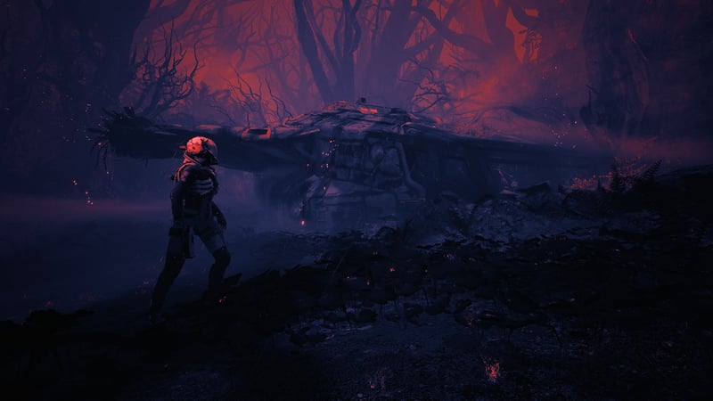Returnal astronaut near a crashed ship in a dark forest
