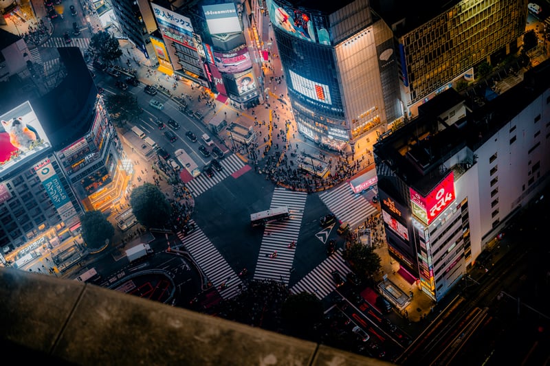 Cars and pedestrians at Shibuya Crossing at night