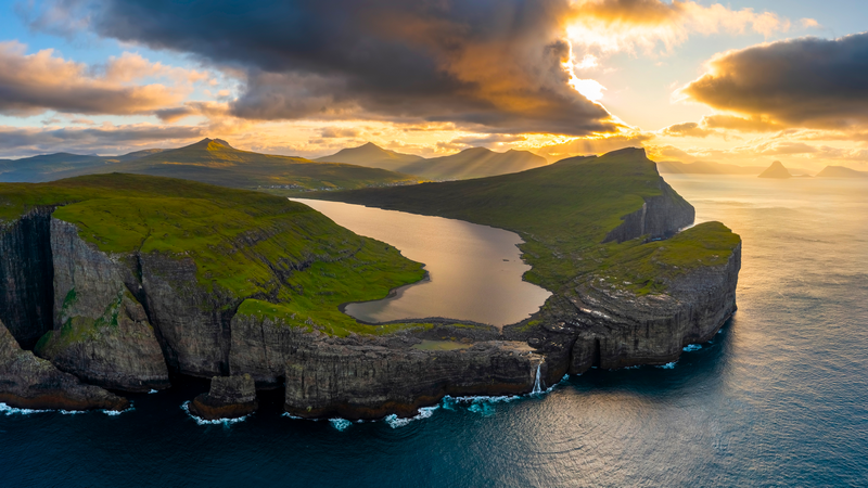 Lake on a cliff overlooking the sea at sunset