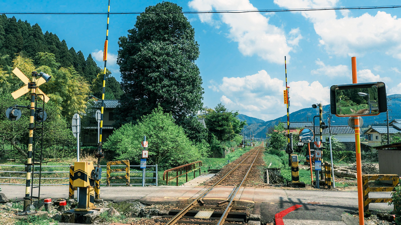 Railway crossing with gates and signal lights in Japan
