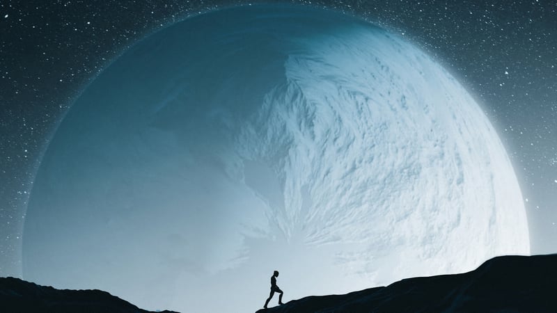 Silhouette of a person walking towards a giant moon