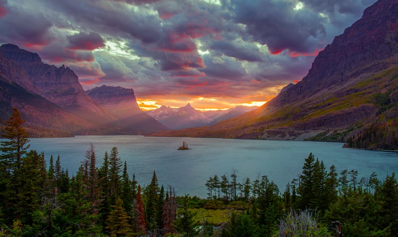 Sunset over a mountain lake with sun rays