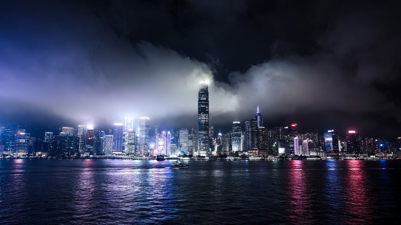 Boat on the water with city lights at night