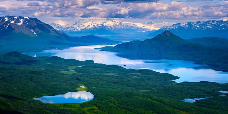 Aerial view of a vast lake and snow-capped mountains