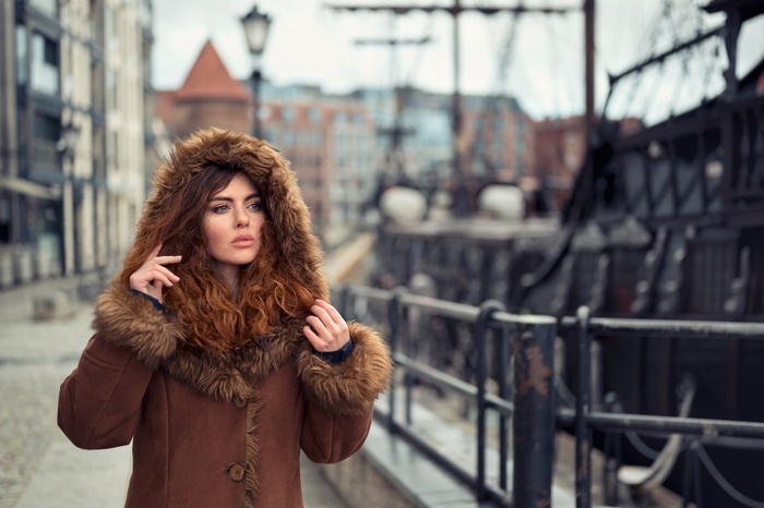 Woman in a fur-lined coat with red hair
