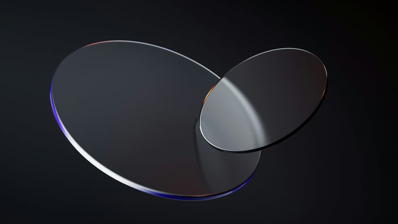Two overlapping glass circles on a dark background