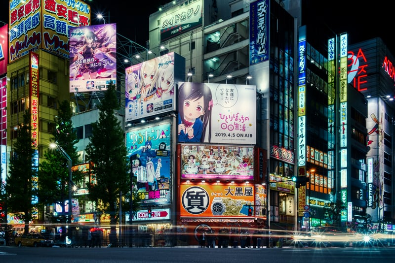 Anime girls on billboards in Akihabara at night