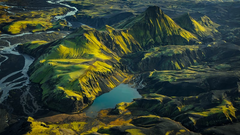 Aerial view of green mountains and a lake