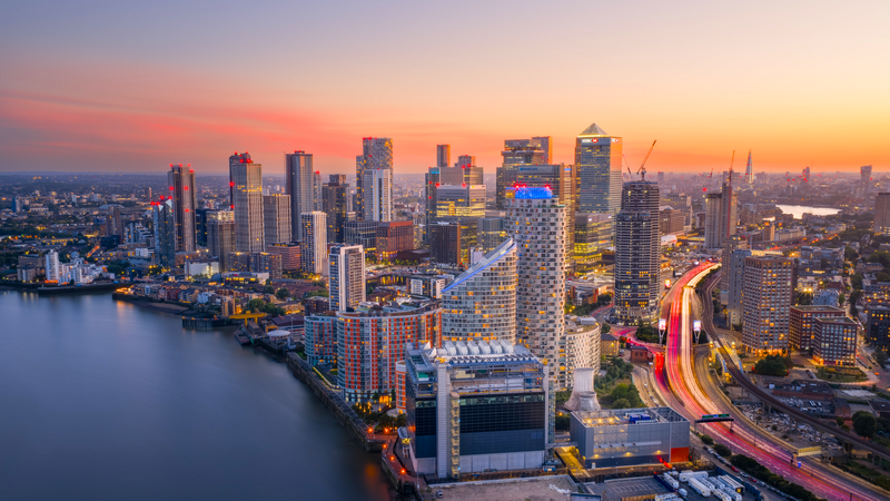 Canary Wharf skyline at sunset with river and highway