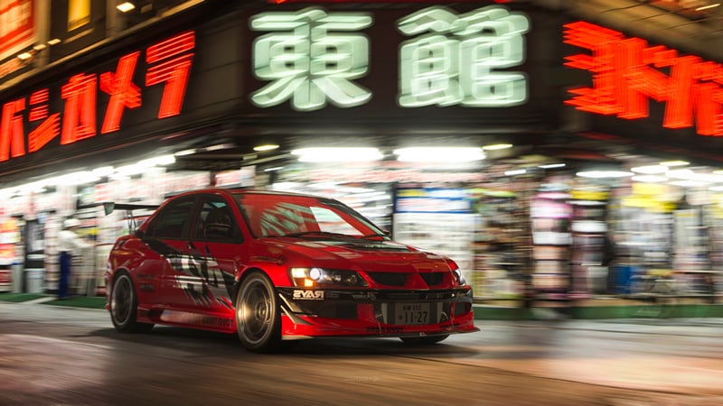 Red Mitsubishi Lancer Evolution IX street racing in Tokyo