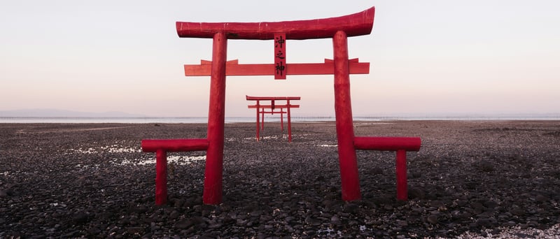 Red Torii Gates on a Rocky Shoreline in Japan