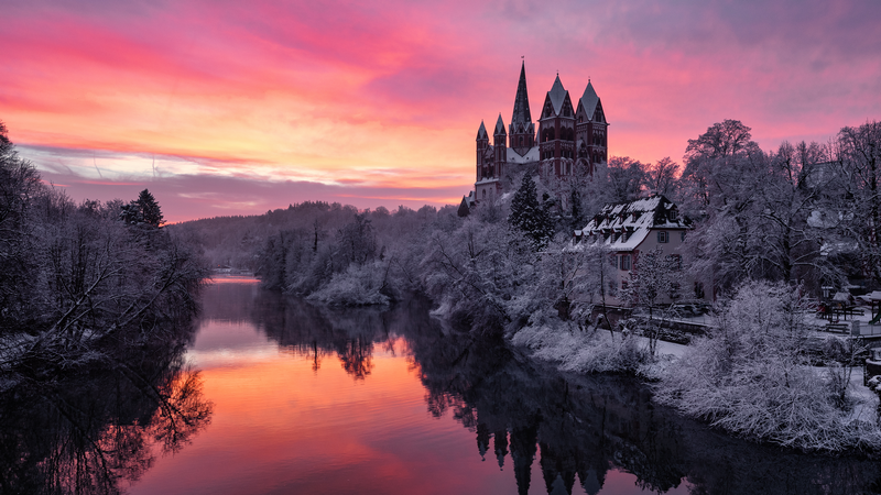 Winter sunrise over a river with a castle