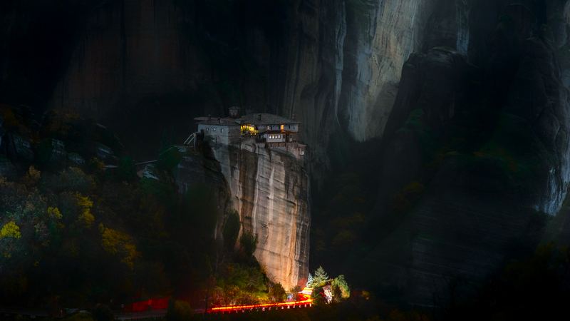 Monastery on a rock formation at night in Meteora, Greece