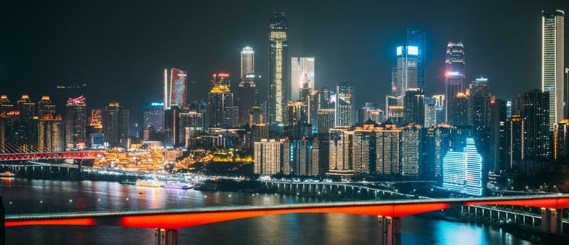 City skyline with river and bridge at night