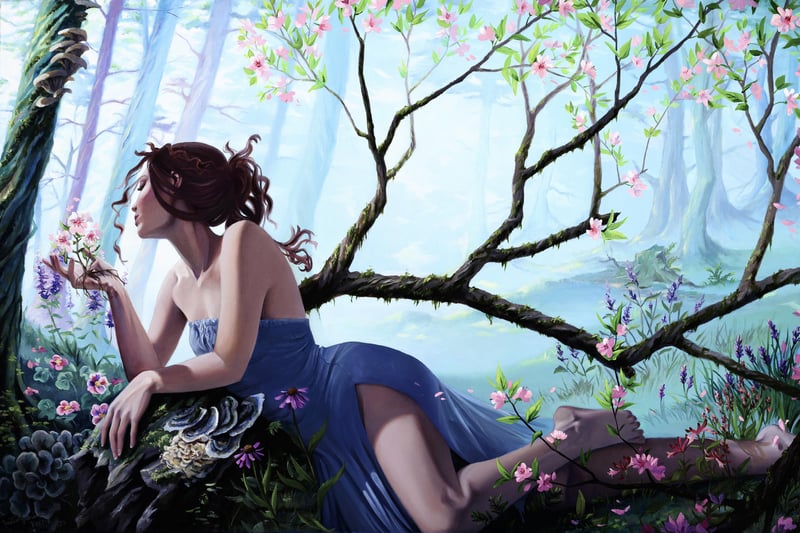 Woman in blue dress smelling flowers in a forest