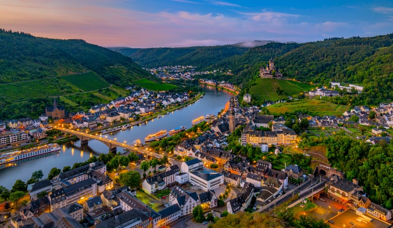 Town on a river with a castle on a hill